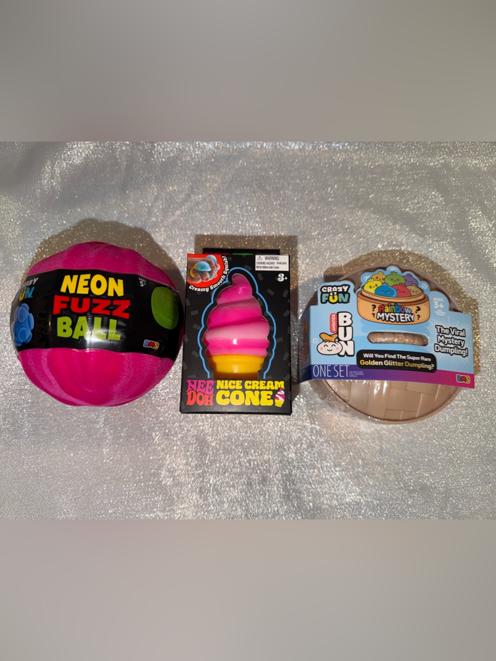 1 NeeDoh Ice Cream, 1 Glitter Mystery Dumpling, 1 Neon Fuzz Ball & 4 Gummy Drops